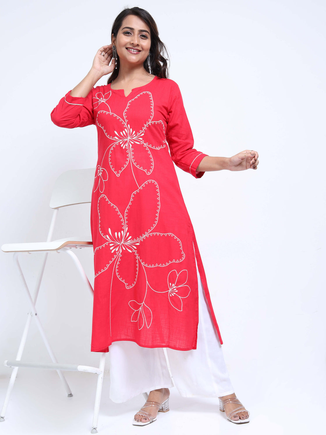 Straight-cut midi kurti with floral embroidery and 3/4 sleeves, paired with palazzos.
