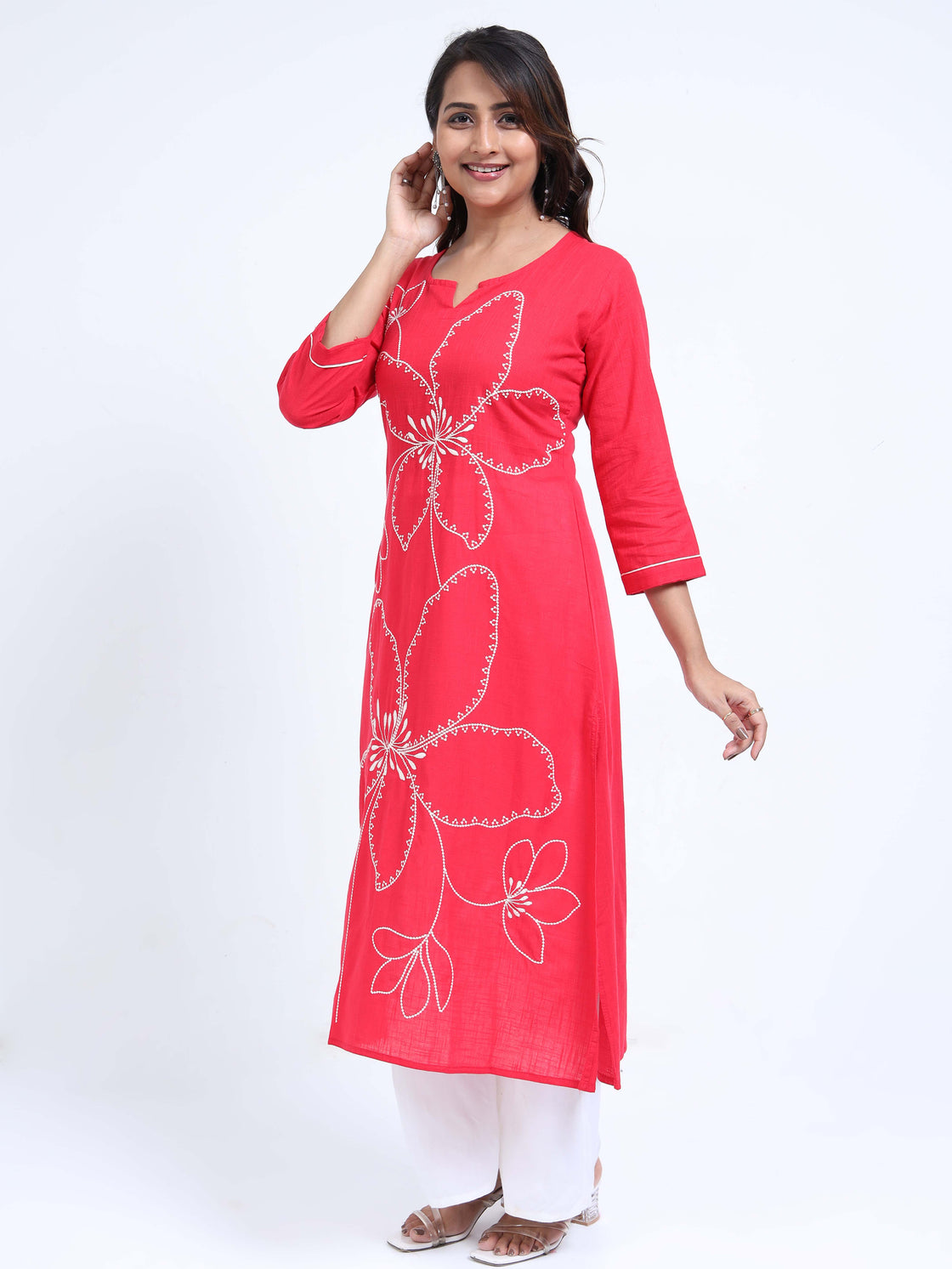Straight-cut midi kurti with floral embroidery and 3/4 sleeves, paired with palazzos.