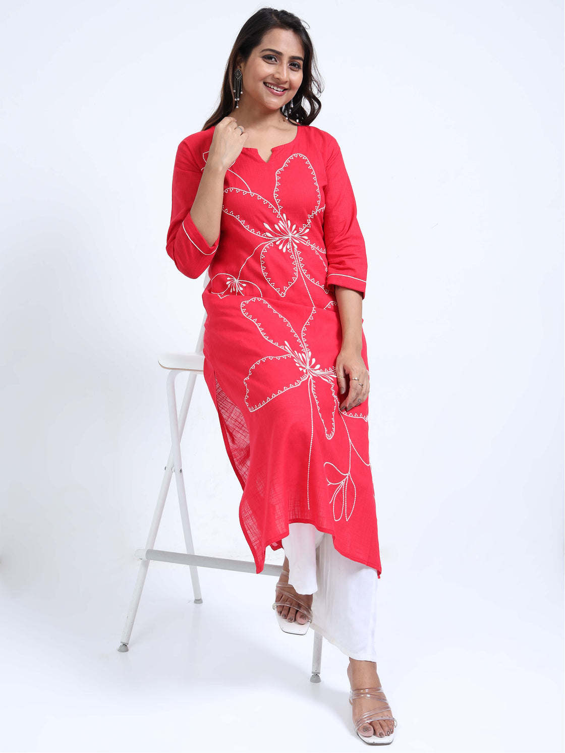 Straight-cut midi kurti with floral embroidery and 3/4 sleeves, paired with palazzos.