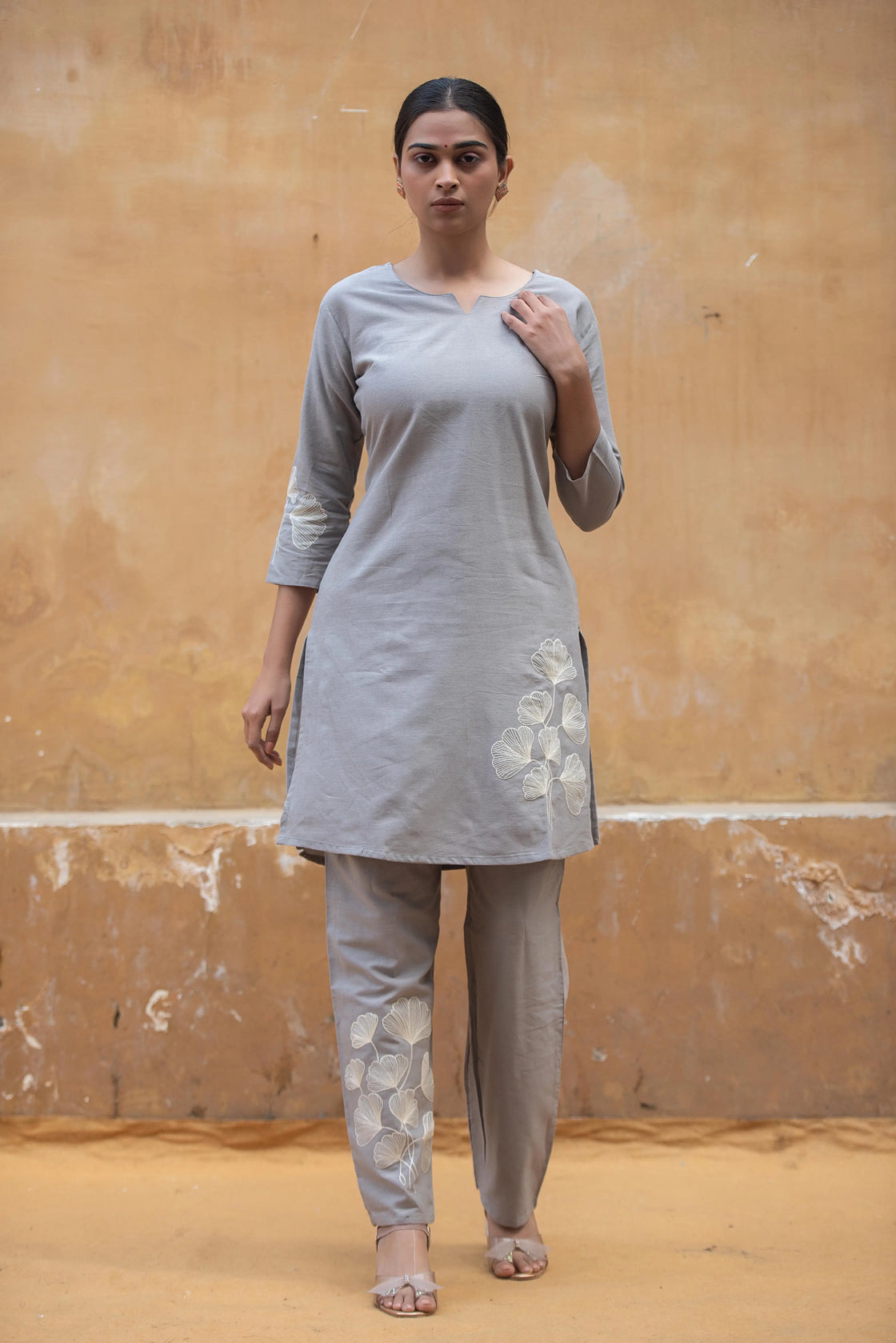 Woman wearing a grey flex cotton co-ord set with floral embroidery, front view.